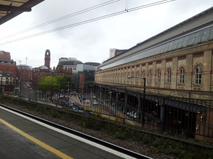 Looking on from platform 13/14 on to one side of the station below, and onto central Manchester.